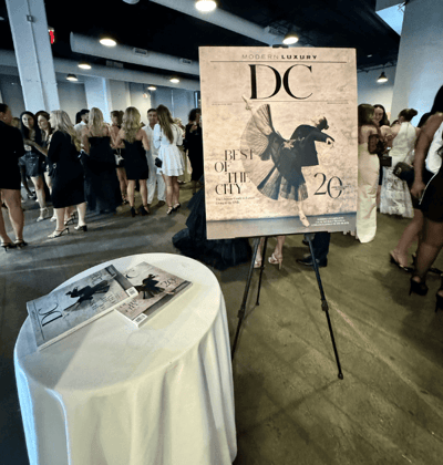 Modern Luxury entrance set up white a white round table and entry sign at DC's best of the city event honoring Chantilly Air.