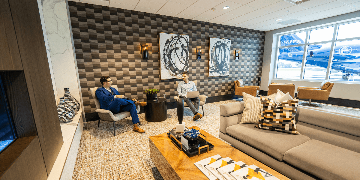 Two clients sitting and talking in the Chantilly Air FBO lounge.