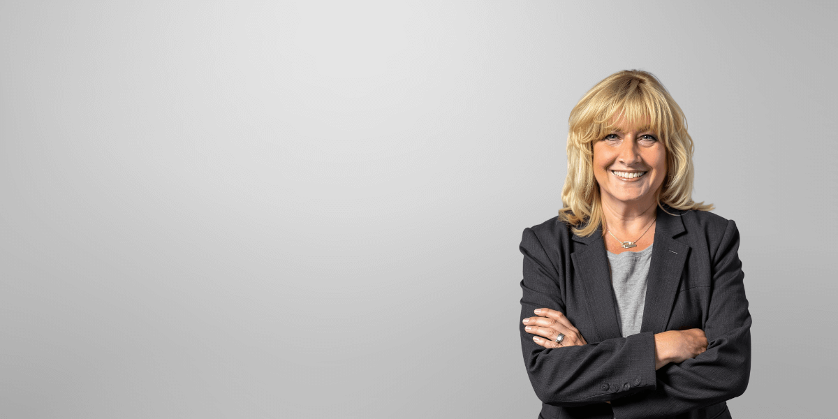 Julie O'Brien headshot with a light grey background.