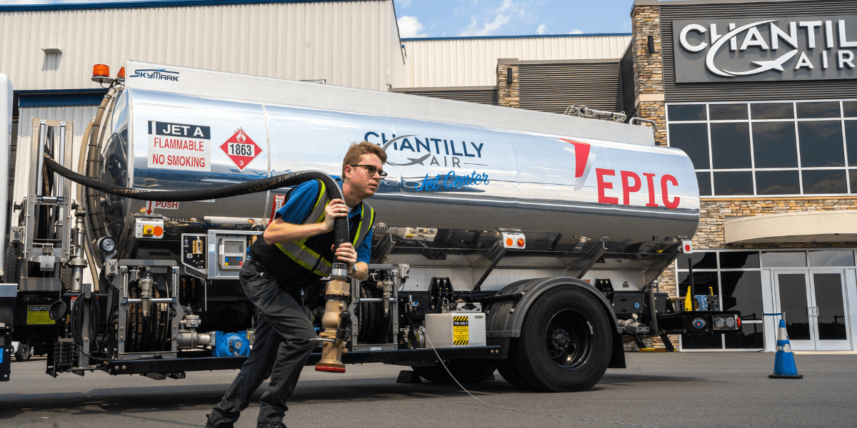 Chantilly Air staff member pulling hose attached to fuel tank