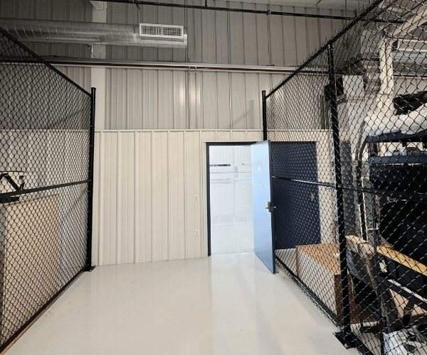 Secure hangar storage cage with gated access for aviation equipment and materials