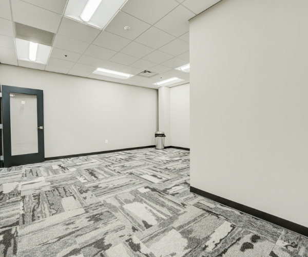 Large second-floor office space with private entry door, open layout, and modern lighting