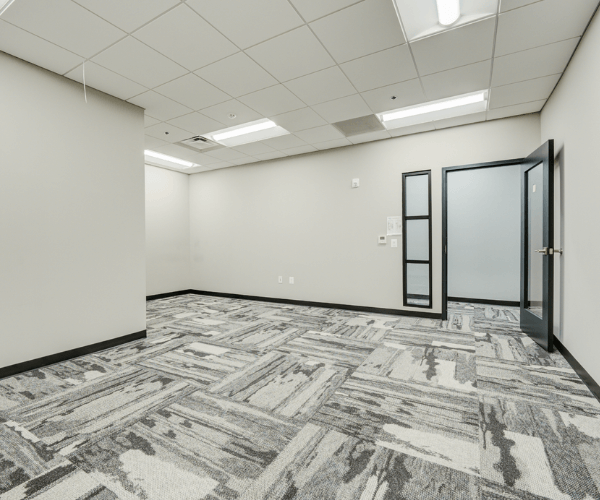 Second-floor office space with open layout, private glass door, and modern finishes