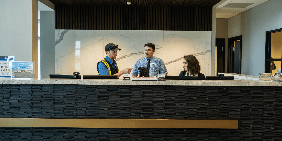 Chantilly Air receptionist and team members speaking behind the front desk