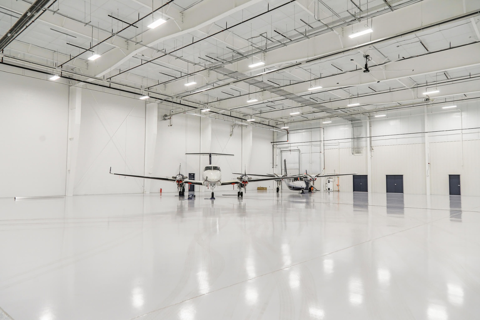 Two small planes in Chantilly Air Hangar.