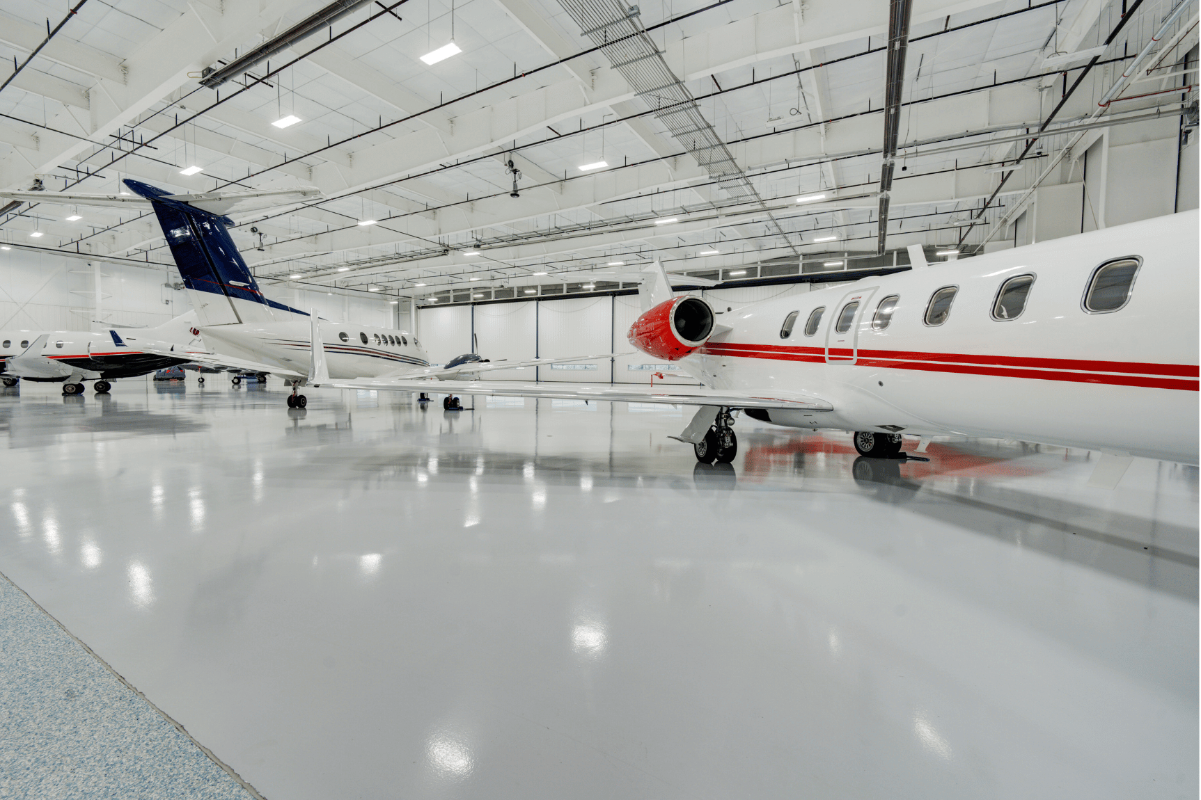 Private jets parked inside Chantilly Air’s 60,000 sq. ft. heated hangar space at Manassas Regional Airport.