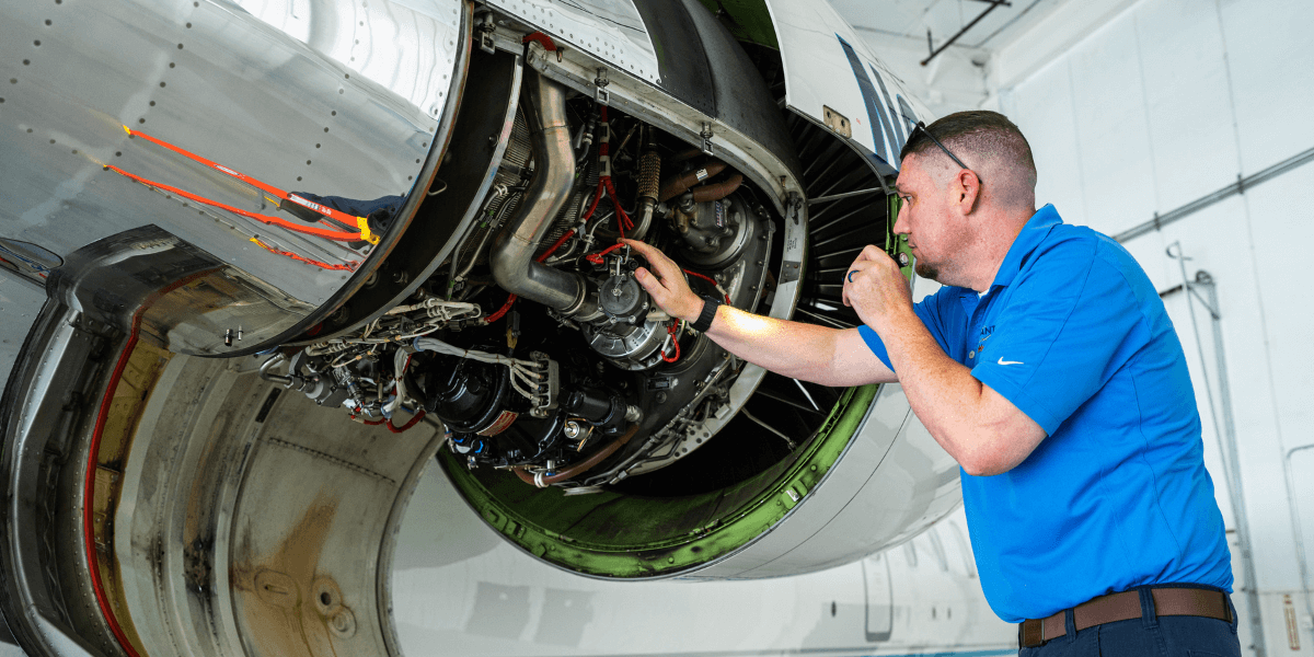 Highly trained maintenance technician working on a jet