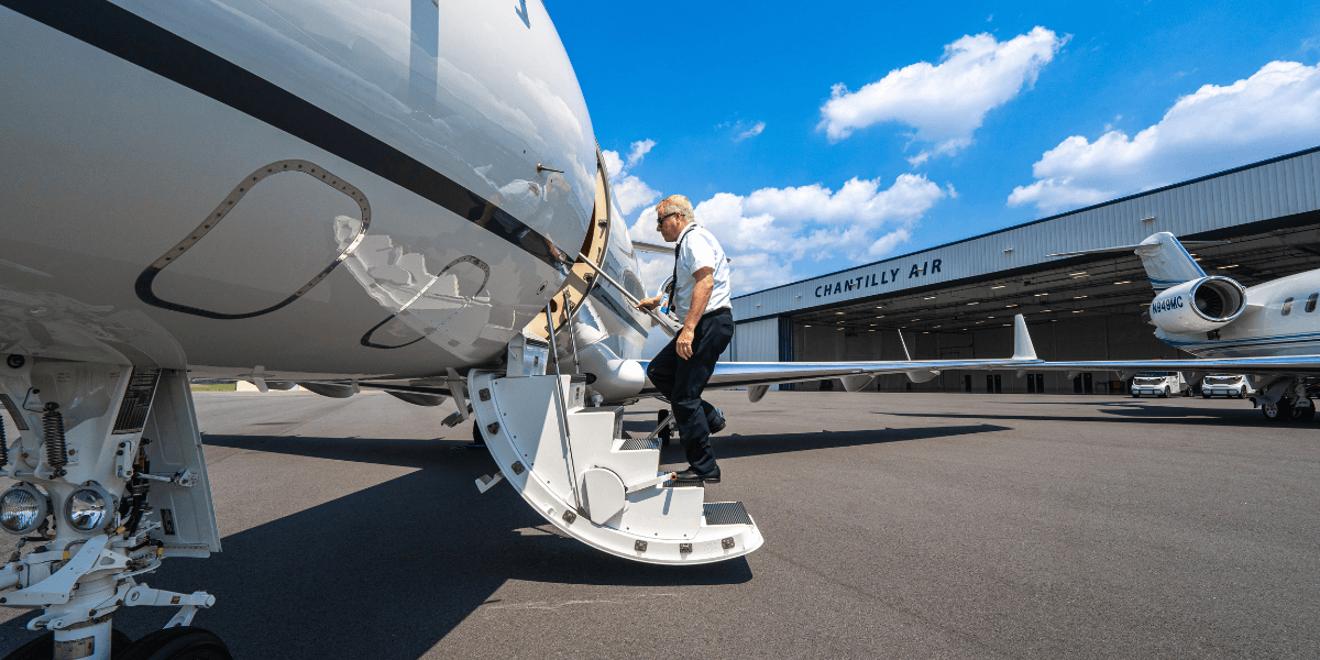 A pilot walking onto a private aircraft