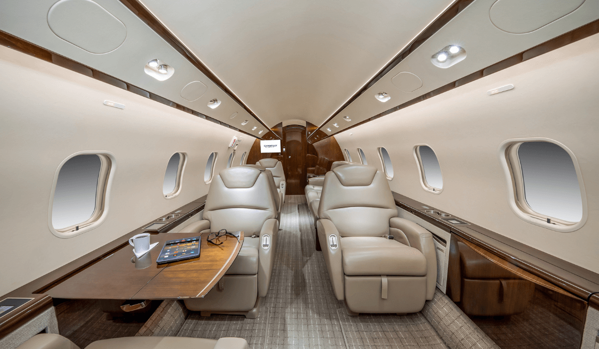 Inside Chantilly Air's Challenger 300 aircraft showing 6 seats, a sofa and a pullout table