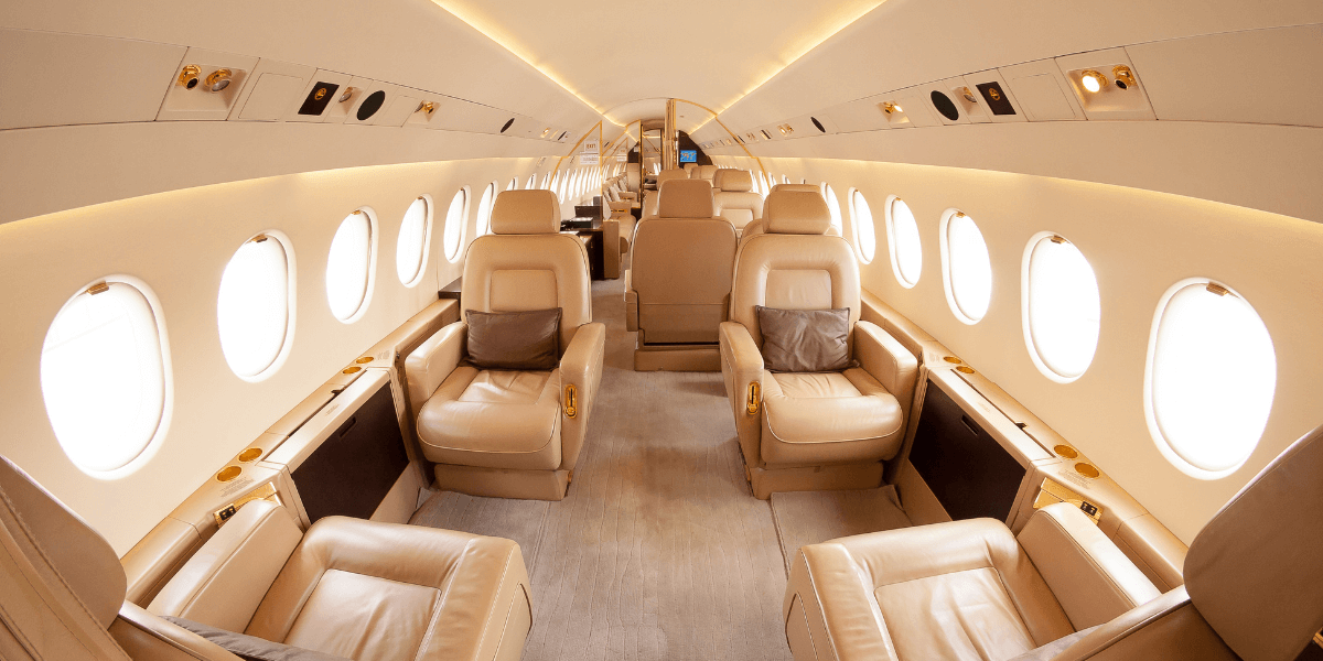 Inside of a private jet with tan interior. 