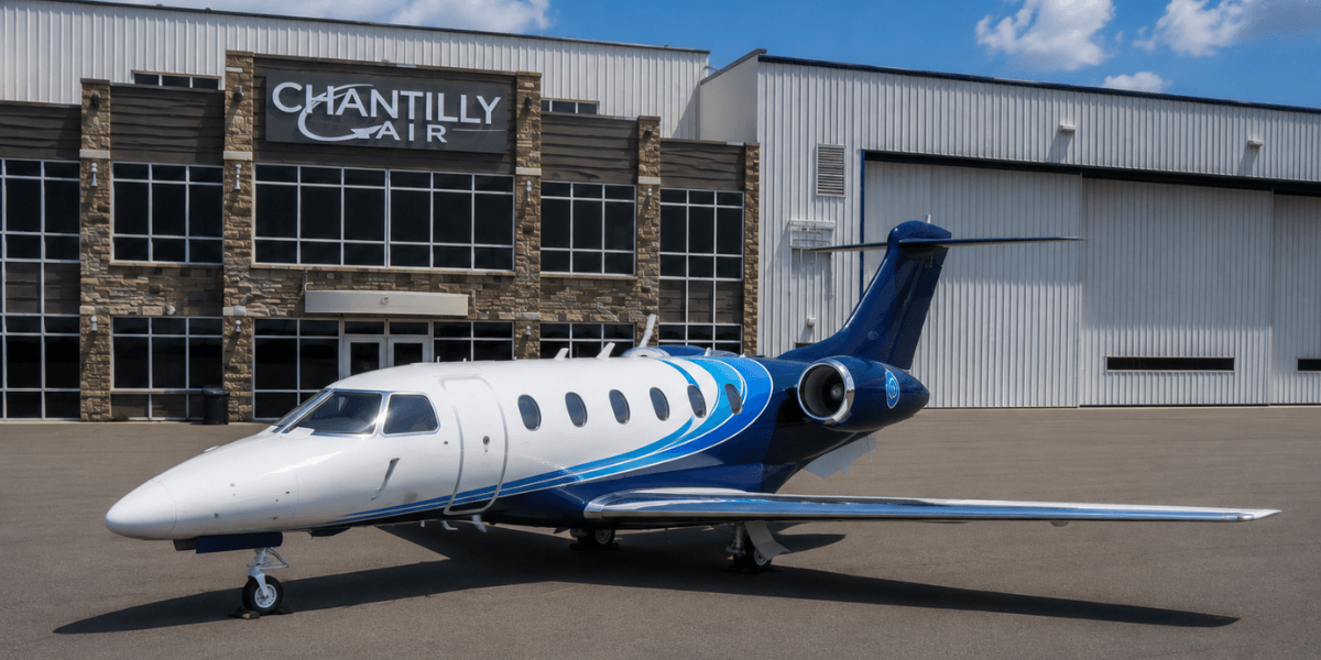 Chantilly Air blue and white light jet in front of the Chantilly Air KHEF fixed base operator
