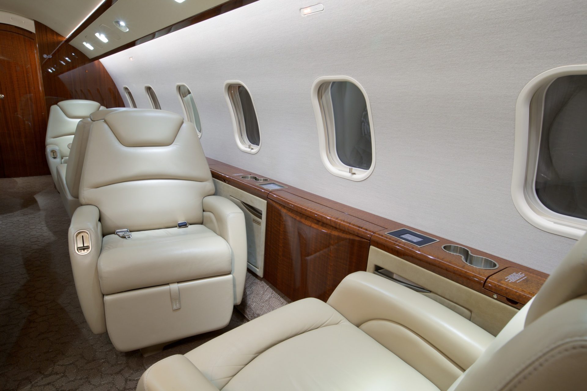 Cabin area with 4 reclining seats along wall